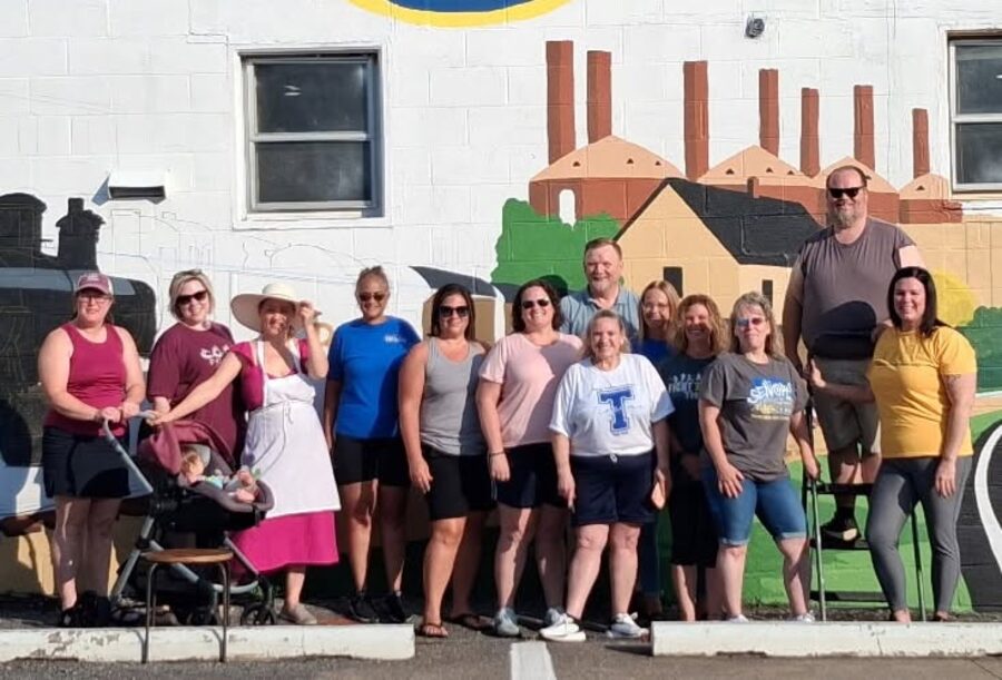 Community volunteers who painted the mural at the district office